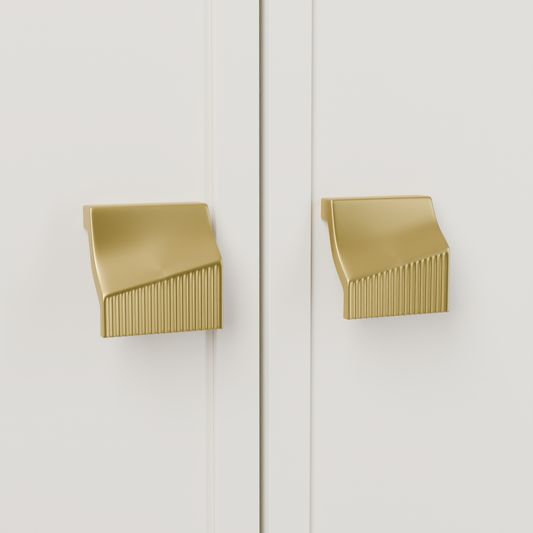 Acrux Knob in Brushed Brass (PVD) installed on warm chalk cabinetry - paired doors, square view