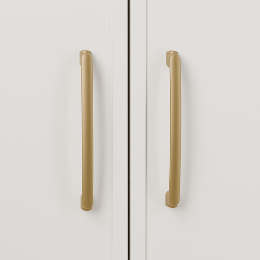 Castor Pull in Brushed Brass (PVD) installed on warm chalk cabinetry - vertical pair, square view