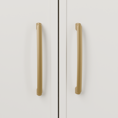Castor Pull in Brushed Brass (PVD) installed on warm chalk cabinetry - vertical pair, square view