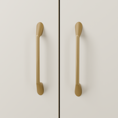 Lyra Pull in Brushed Brass (PVD) installed on warm almond cabinetry - vertical pair, square view