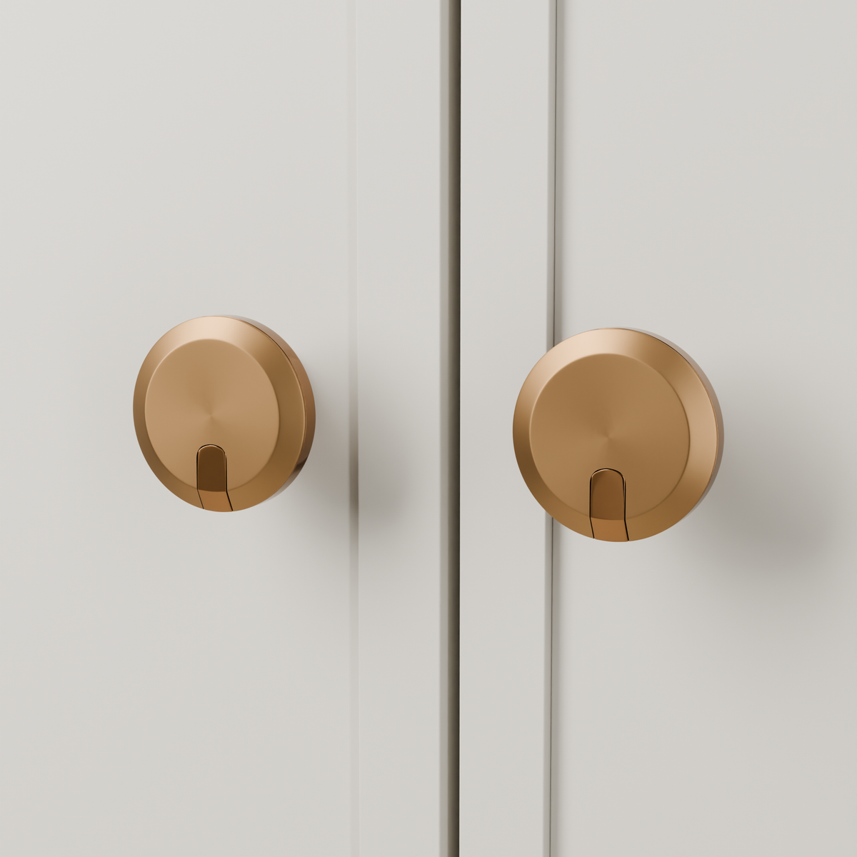 Orion Knob in Brushed + Polished Copper (PVD) installed on oyster stone cabinetry - paired doors, square view