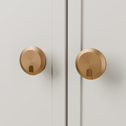 Orion Knob in Brushed + Polished Copper (PVD) installed on oyster stone cabinetry - paired doors, square view