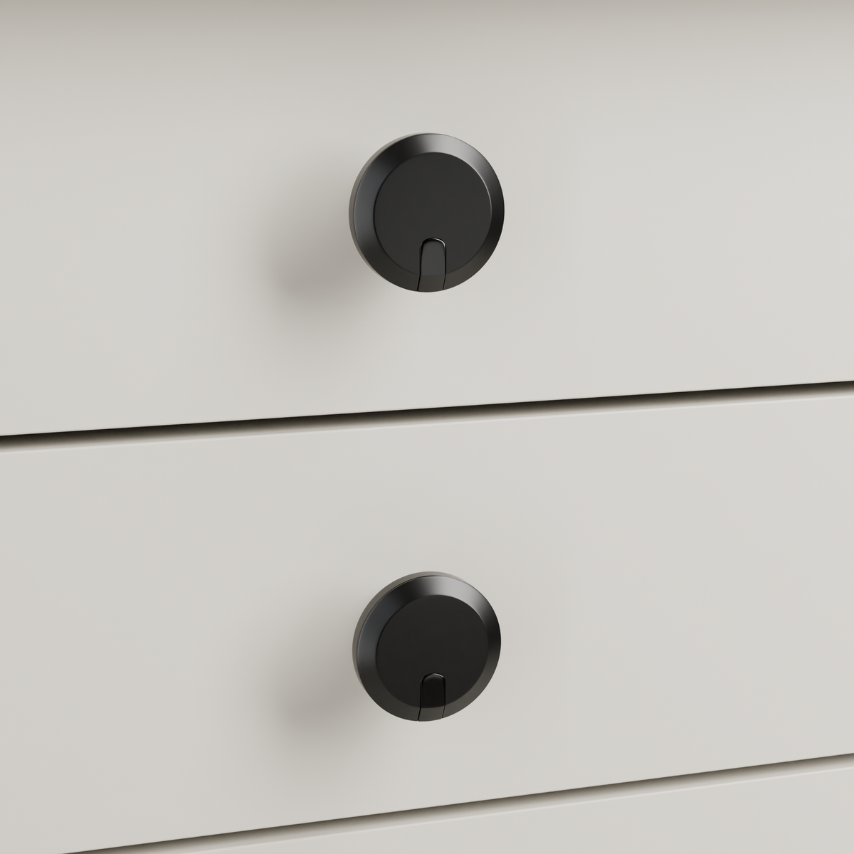 Orion Knob in Polished Black + Matte Black installed on oyster stone cabinetry - drawer detail, square view