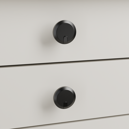 Orion Knob in Polished Black + Matte Black installed on oyster stone cabinetry - drawer detail, square view