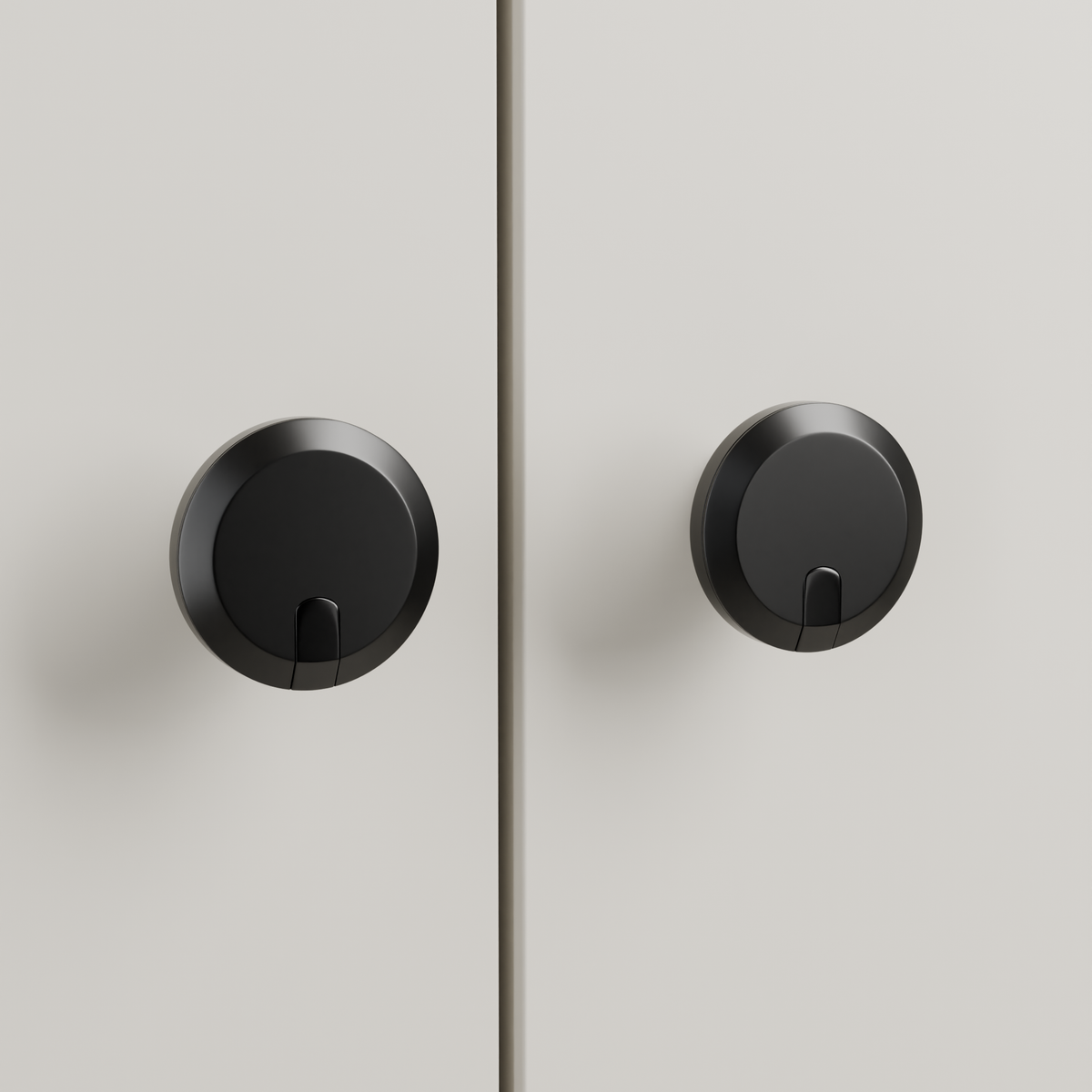 Orion Knob in Polished Black + Matte Black installed on oyster stone cabinetry - paired doors, square view