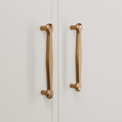 Orion Pull in Brushed + Polished Copper (PVD) installed on warm chalk cabinetry - vertical pair, square view