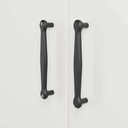 Orion Pull in Polished Black + Matte Black installed on warm chalk cabinetry - vertical pair, square view