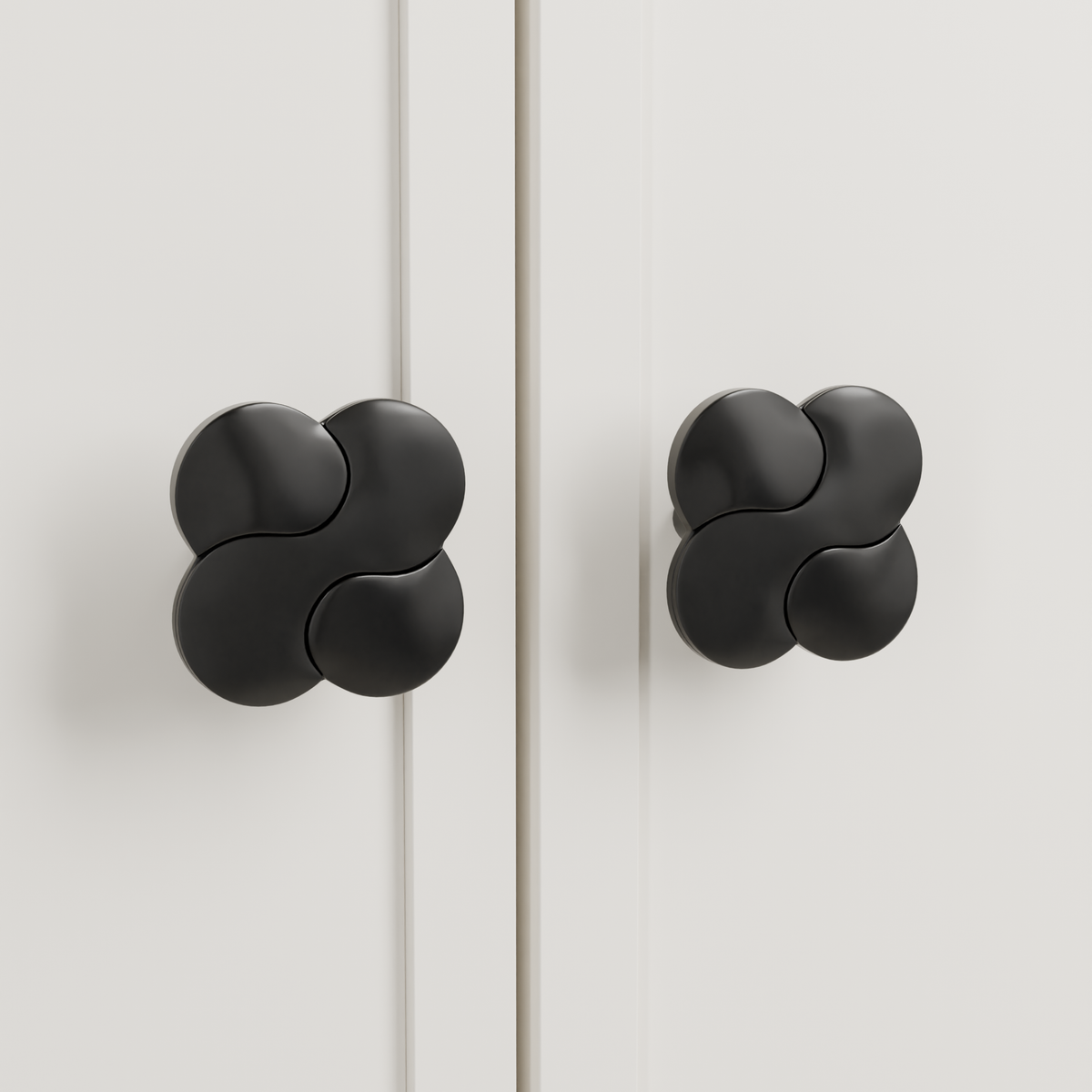 Saiph Knob in Polished Black + Matte Black installed on warm chalk cabinetry - paired doors, square view